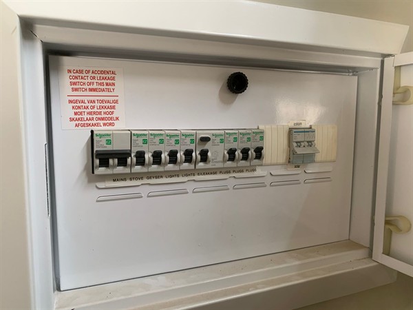 Open hot water geyser during thermostat and element repair in Bassonia Rock with internal components visible