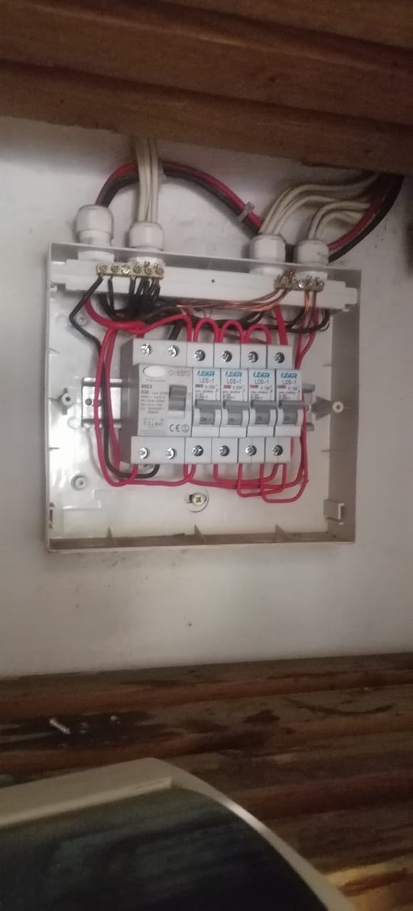 Ceiling mounted geyser opened during element and thermostat repair in Sunair Park showing internal wiring