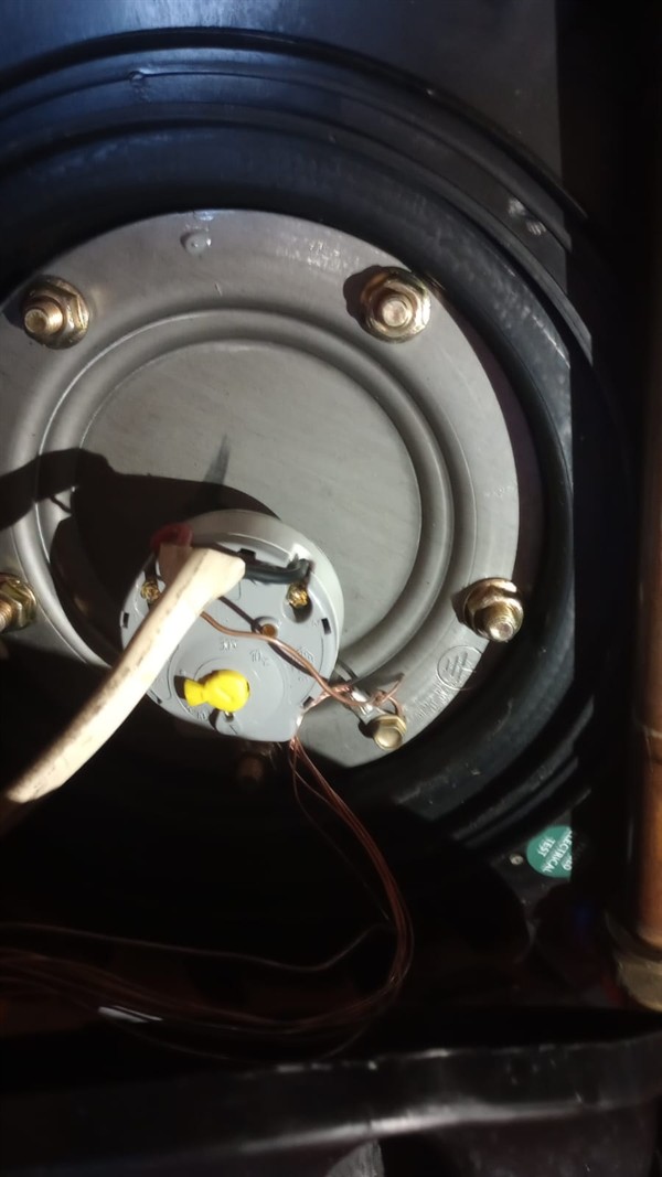 Ceiling mounted geyser opened during element and thermostat repair in Bardene showing internal wiring