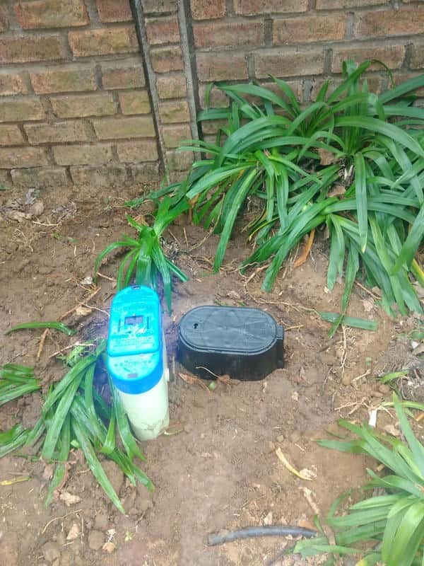 Water running down leaking water meter in Platberg