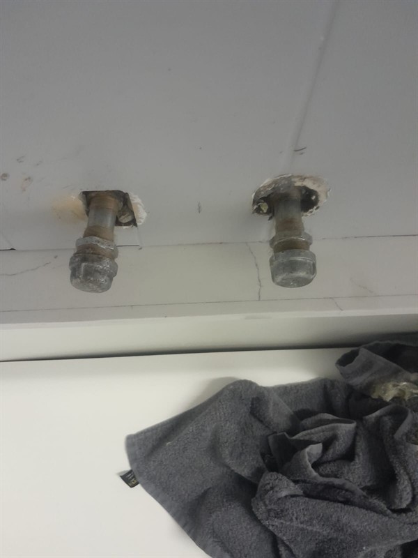 Technician working on basin angle valve replacement in Derdepoort Resort