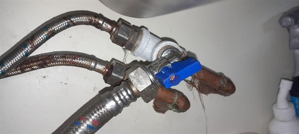 Damaged angle valve with tools laid out in Dorandia