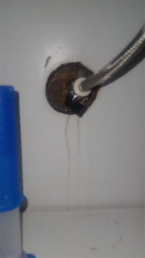 Plumber fixing leaking toilet valve