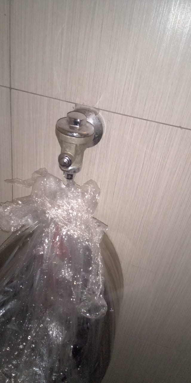 Leaking urinal flush valve in Linden with water overflowing from urinal, showing faulty flushing system before repair and water running continuously over stainless steel urinal.