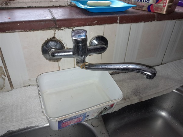 Open hot water geyser during thermostat and element repair in Hugh Wyndham Park with internal components visible