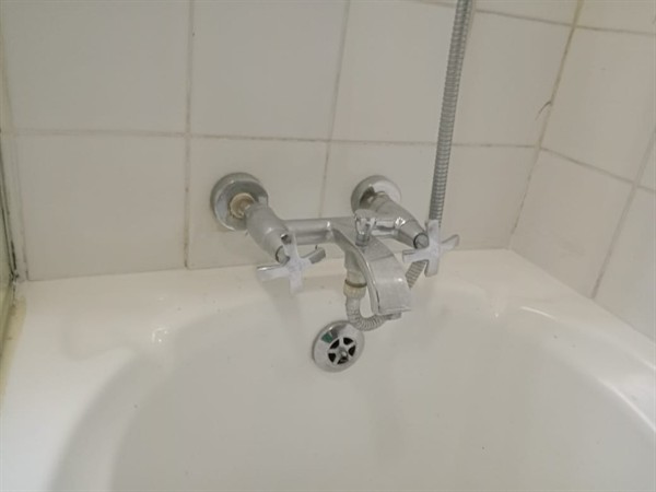 Technician repairing open geyser element and thermostat in Elsburg with exposed wiring and heating components