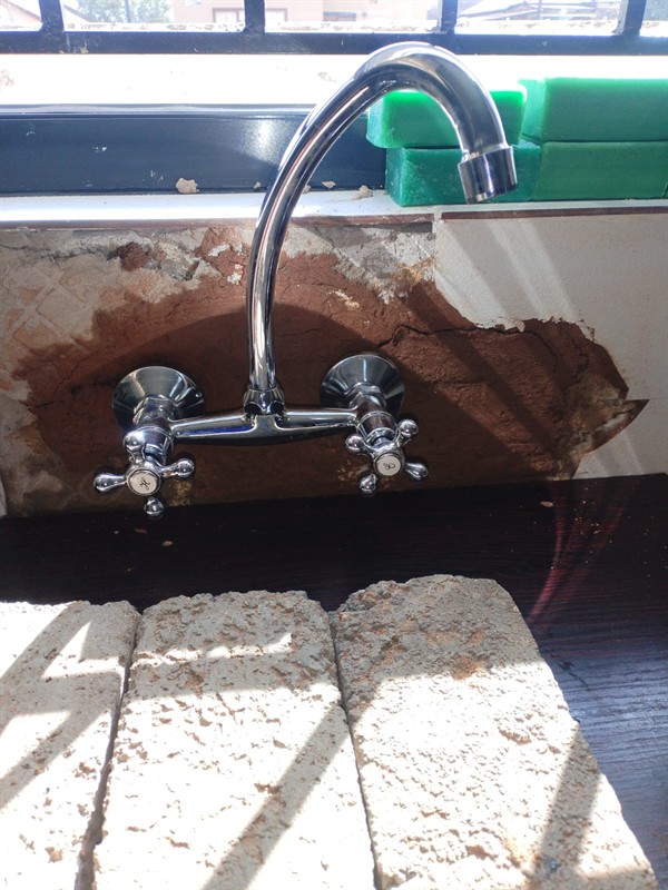 Open geyser showing heating element and thermostat repair work in Protem with exposed wiring and internal components