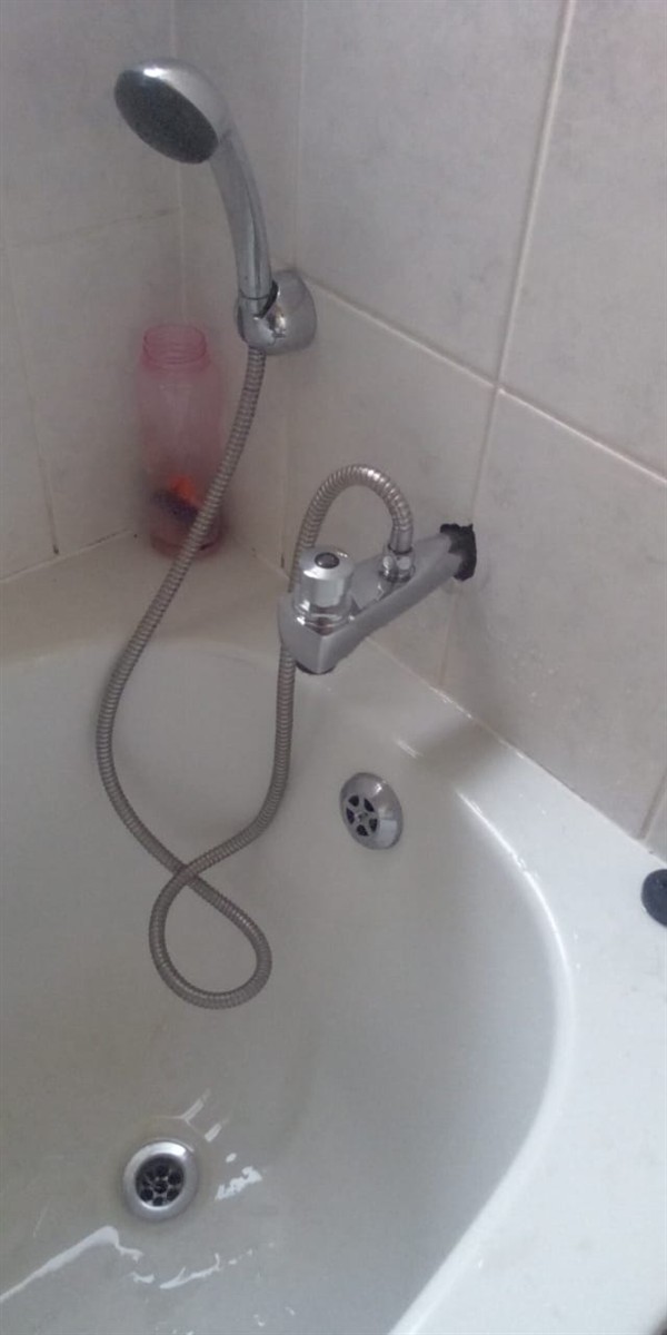 Open hot water geyser during thermostat and element repair in Denver with internal components visible