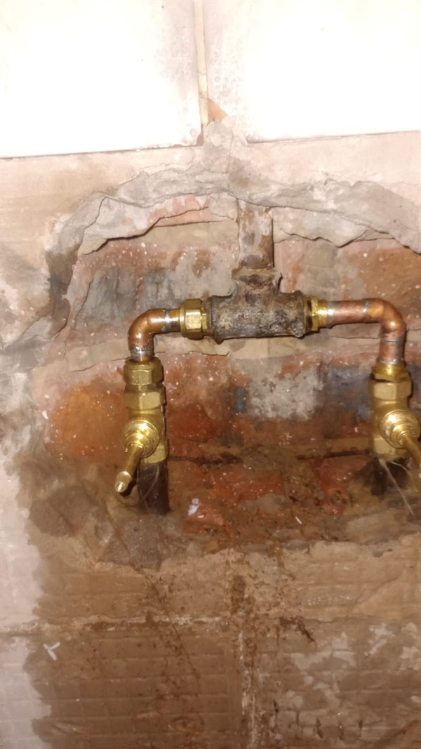 Ongoing dripping and stains from burst pipe inside wall in Modderfontein Industrial