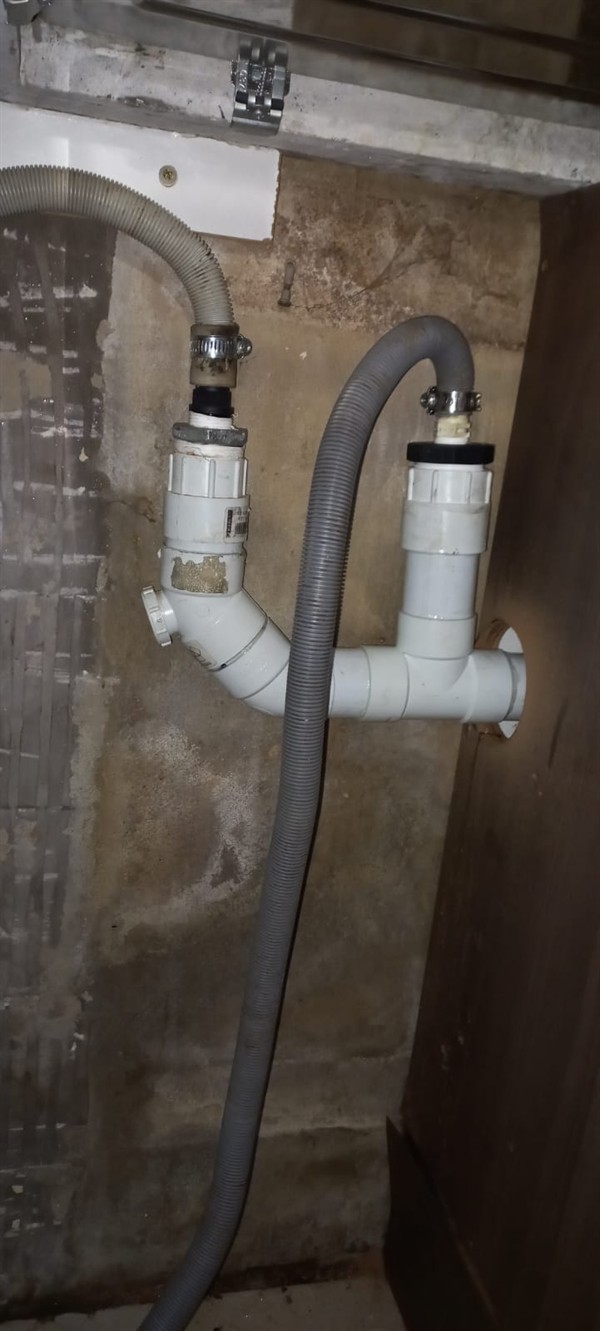 Open geyser showing heating element and thermostat repair work in Manufacta with exposed wiring and internal components