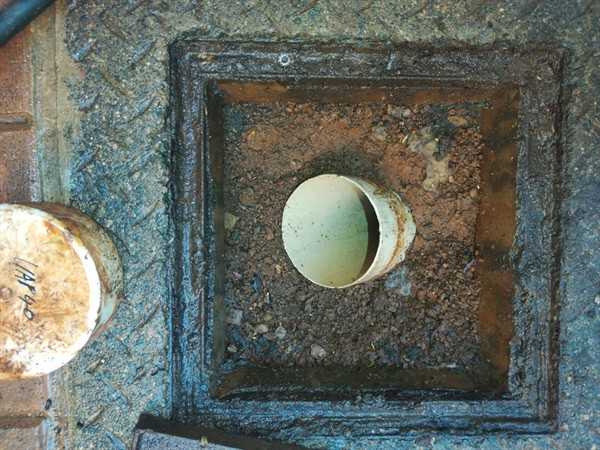 Completely blocked drain pipe with dirty standing water