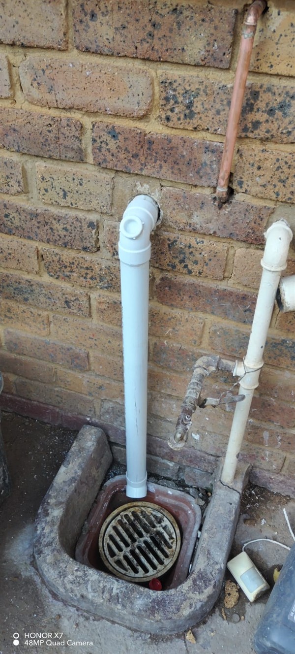 Hands fixing blocked gulley