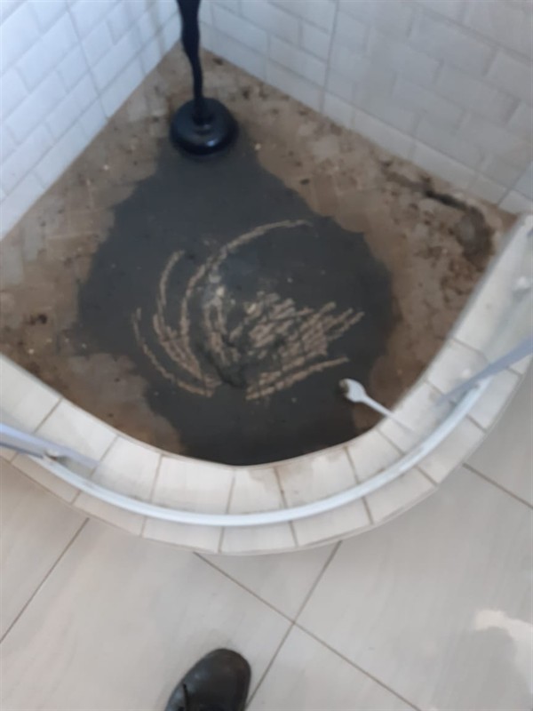 Slow draining drain pipe with water pooling around the opening