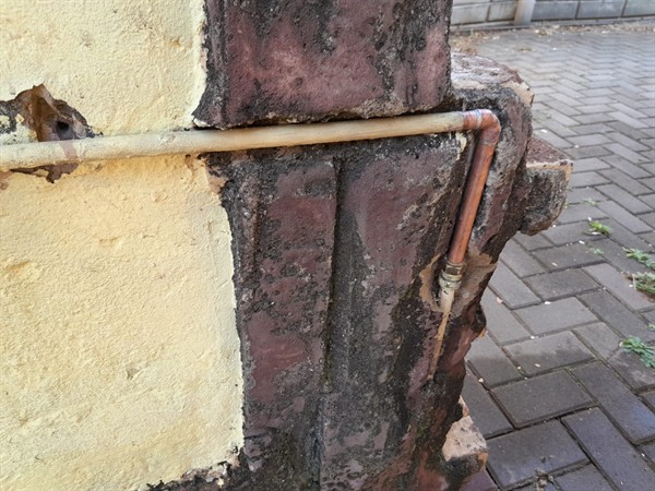 Damp patches on wall from burst pipe in Allen Grove