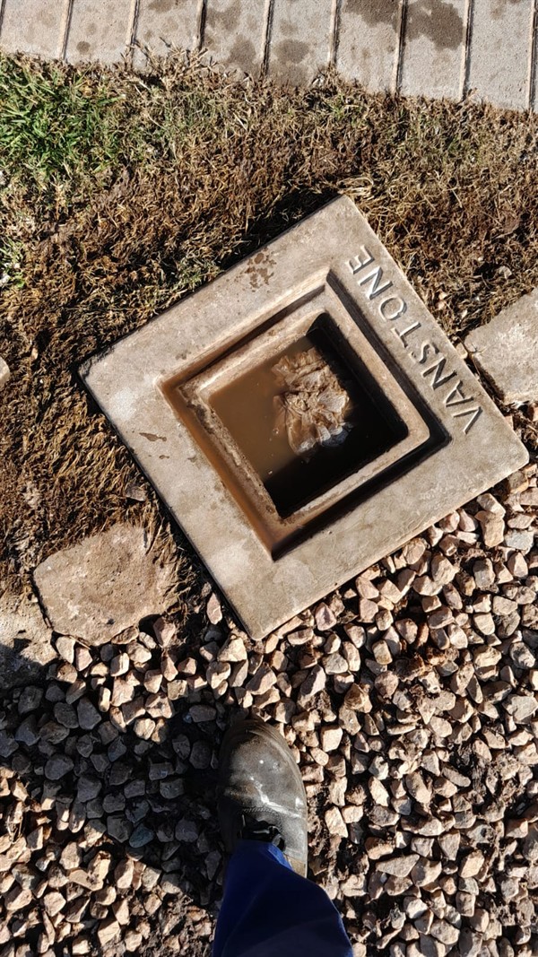 Heavy blockage visible inside drain pipe