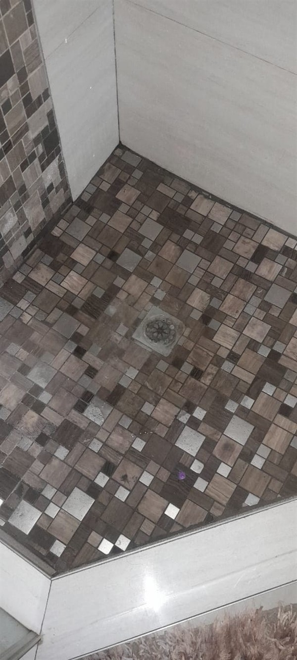 Technician working on blocked shower drain