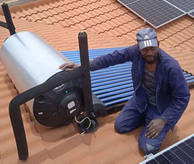 Solar Geyser Roof Repair Plumber working on a roof-mounted solar geyser and solar collector tubes