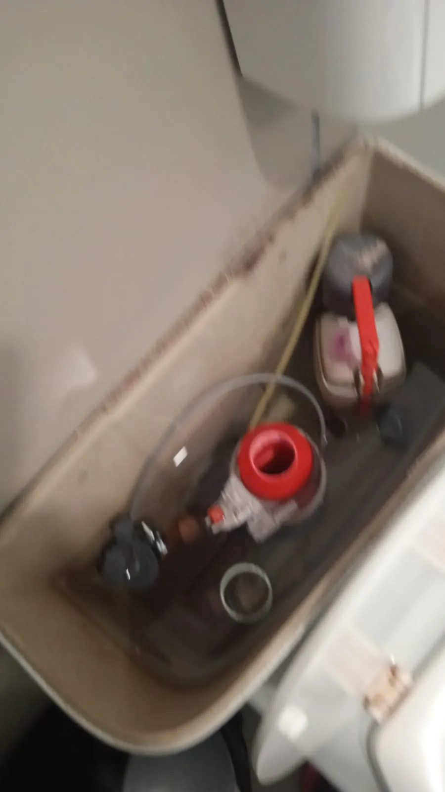 Toilet Cistern Repair Open toilet cistern showing internal flushing mechanism being repaired