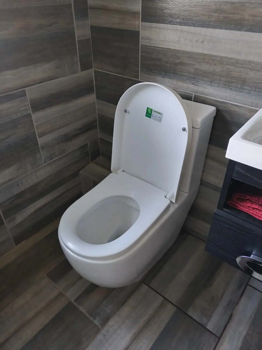 Toilet Installation New toilet installed in a tiled bathroom with seat and cistern fitted