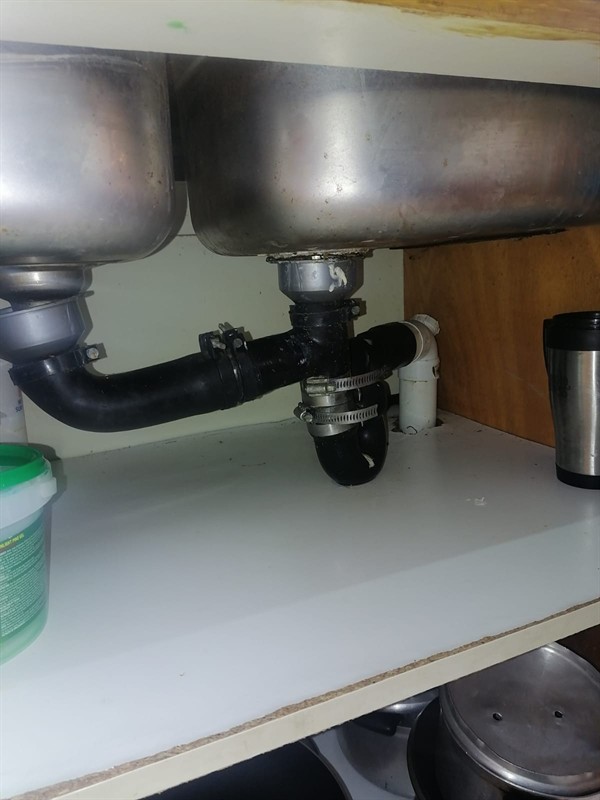 Technician repairing open geyser element and thermostat in Primrose East with exposed wiring and heating components