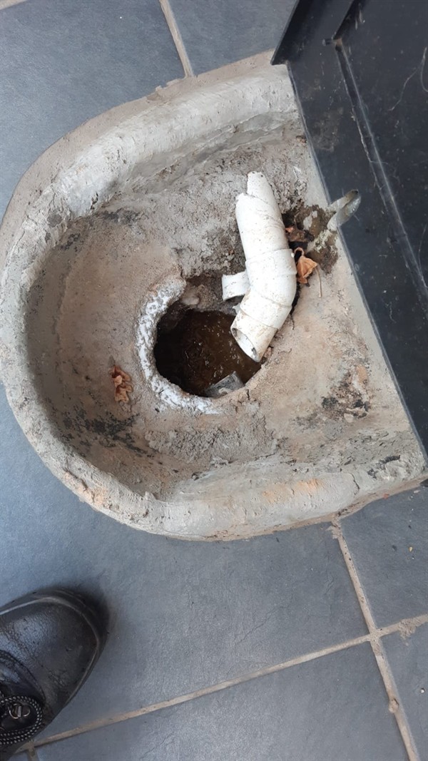 Blocked drain showing visible debris and standing water inside