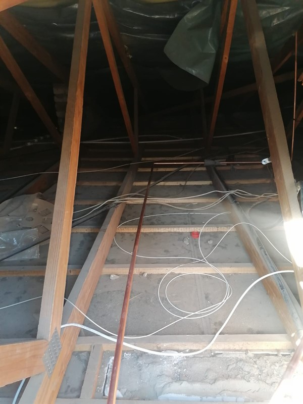 Water leaking from ceiling due to burst pipe behind plaster in New Brighton