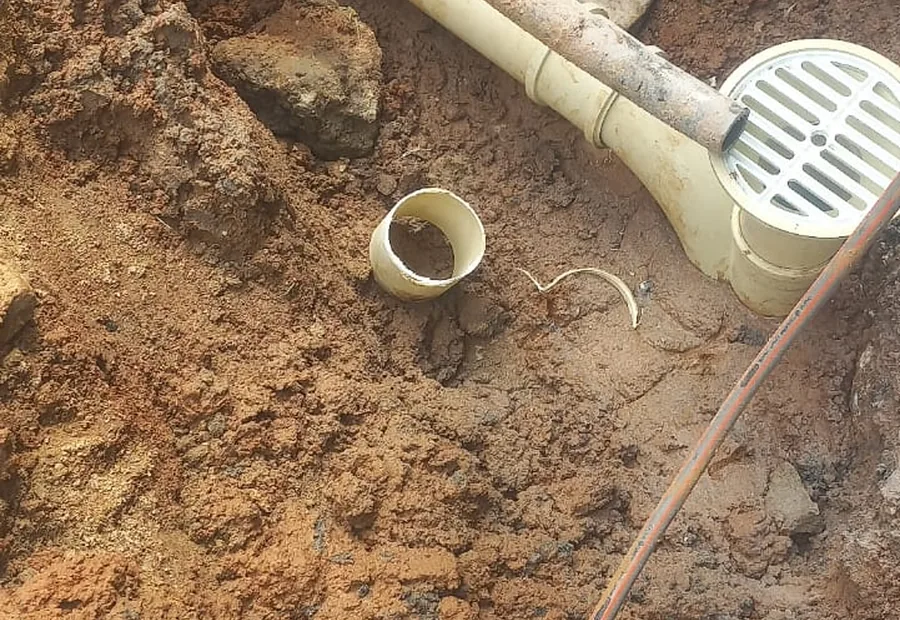 Underground Drain Line Repair Waterkloof showing an excavated drain line and gully connection