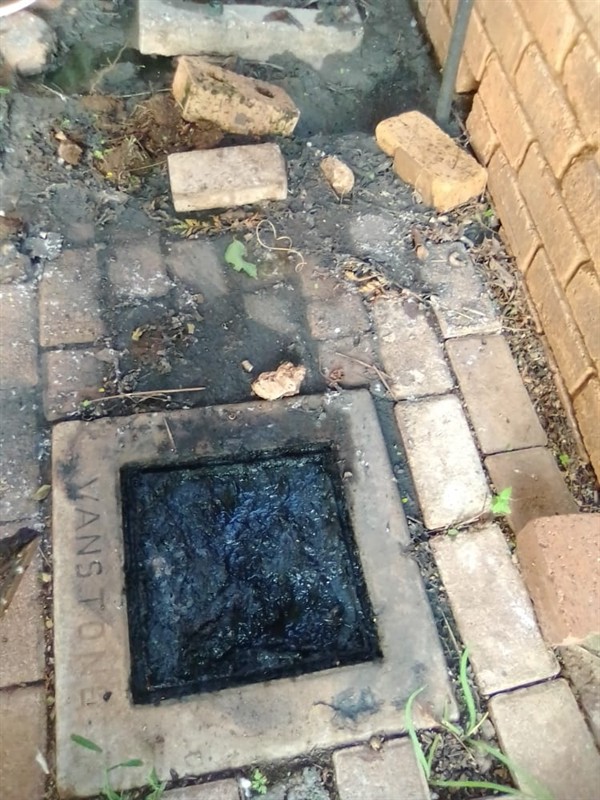 Fully blocked drain filled with water that refuses to flow away