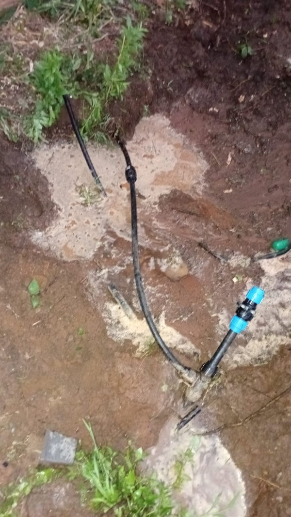 Water leaking from underground burst pipe causing higher bills in Winnie Camp