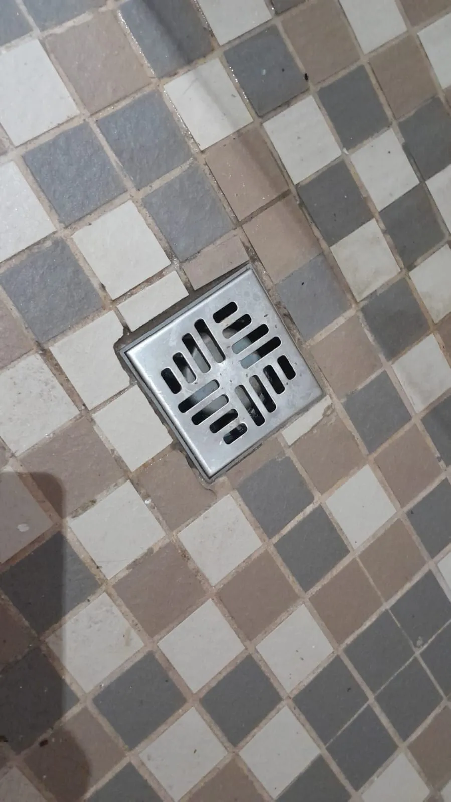 Square shower waste after blocked shower cleaning and testing.