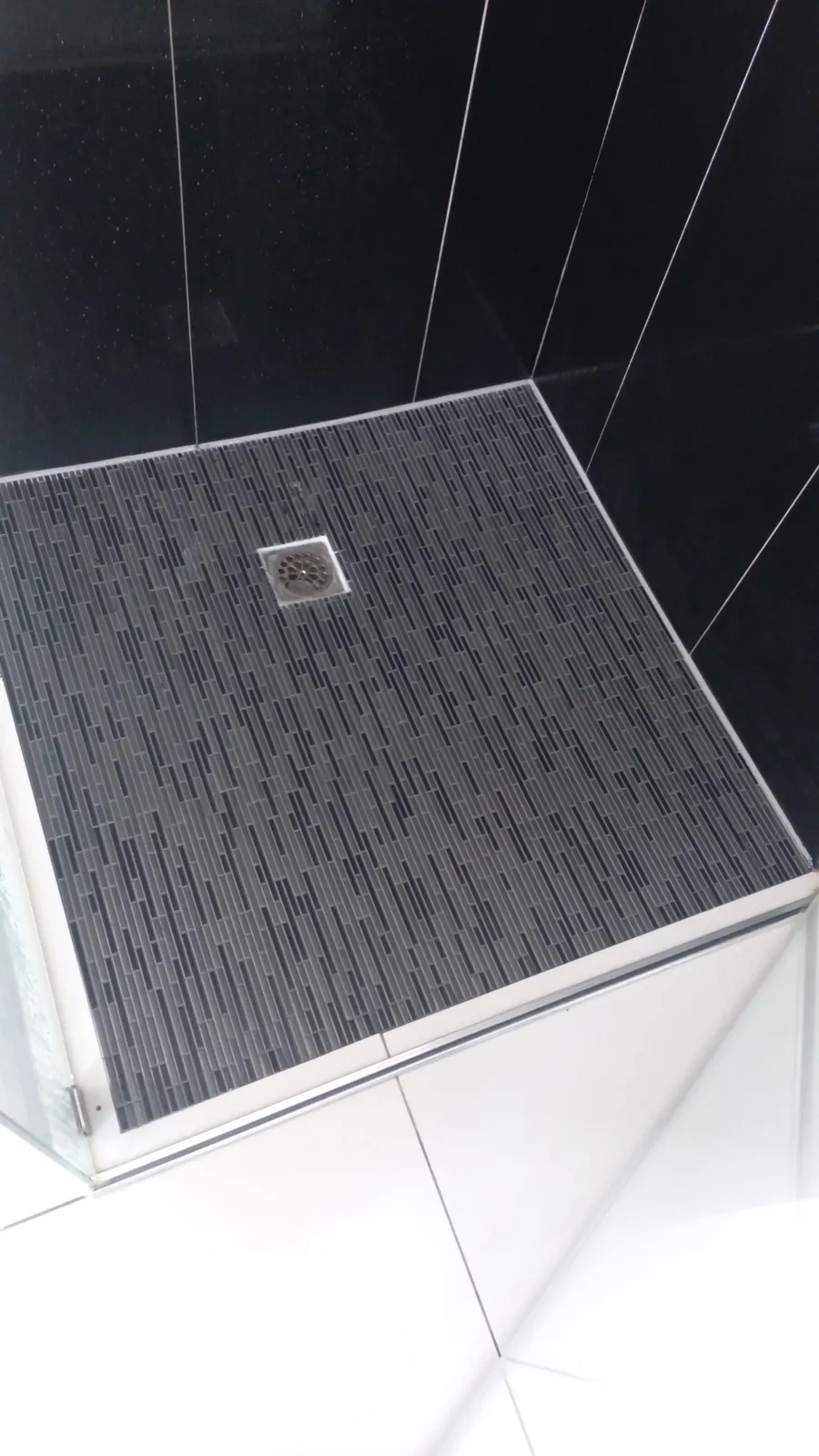 Modern shower floor drain flowing correctly after cleaning.