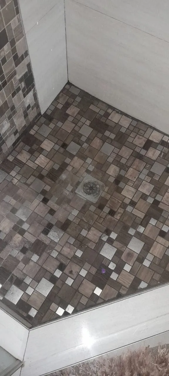 Blocked shower drain cleared and tested for proper flow.